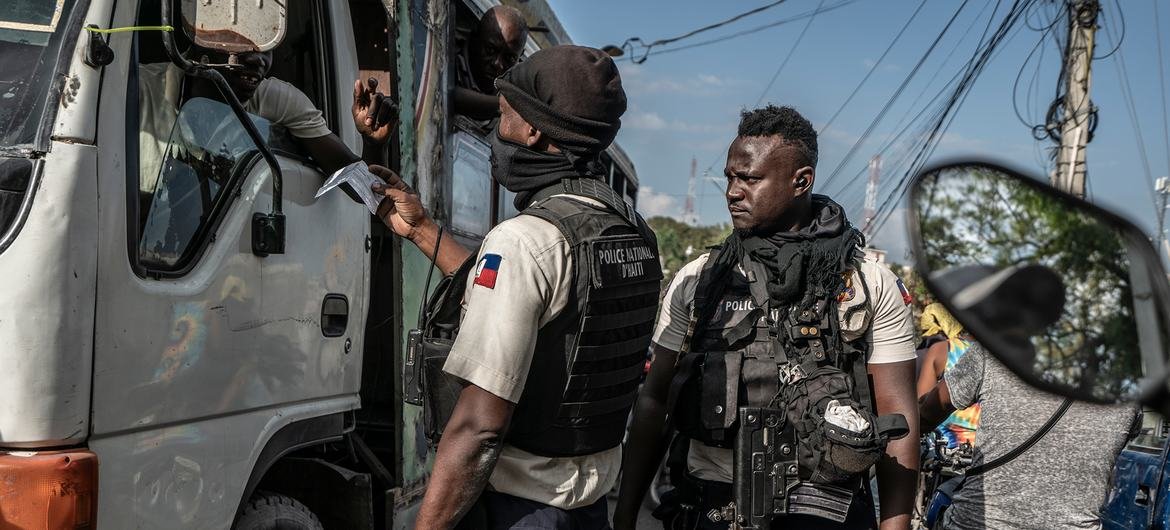 Polícia haitiana verifica documentos de motorista em posto de controle