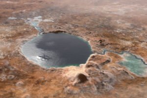 Lago circular de água escura rodeado por terreno árido e marrom. Pequenas elevações e áreas de água mais clara aparecem próximas à margem direita do lago.